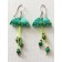 Boucles d'oreilles Méduses, no 24, de l'artiste Molusk, Bijou mode d'inspiration aquatique souple et léger. La matière première : un PVC transparent qui, une fois coloré, doré et imprimé, est totalement métamorphosé.