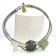 Bracelet TUBE CUBE, no 83, de l'artiste Sandrine Giraud. Couleur gris argent et cubes blanc-gris foncé-olive. Ce bijou marie avec élégance la grâce et l’originalité des lignes.